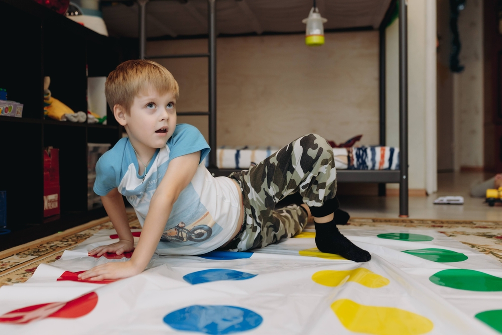 Ребенок играет в твистер дома